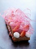 Shortbread biscuit with stewed rhubarb, strawberries, meringues and cotton candy