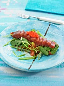 Tuna sashimi with rocket lettuce, confit tomatoes and corn lettuce