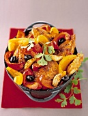 Caramelized chicken with red and yellow peppers and black olives
