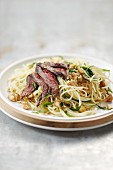Sauteed spaghettis with beef and peanuts