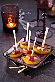 Gorgonzola wrapped in smoked duck magret and peach brochettes