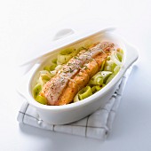 Salmon wrapped in bacon with braised leeks