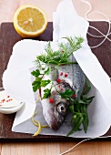 Sea bass with herbs to be cooked in wax paper