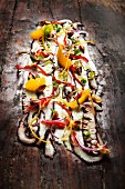 Giant octopus ceviche with orange and peppers