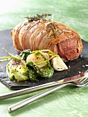Beef fillet wrapped in lard,pak-choi cabbage with spring turnips