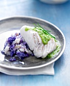 Piece of cod with creamy chive sauce,purple potato and celeriac mash