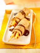 Rolled pancakes with dried fruit and chocolate sauce