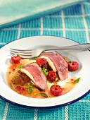 Duck magret with stewed apples and raspberries