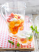 Fizzy white wine Sangria with watermelon and melon balls