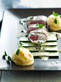 Lamb fillet with raw zucchinis and mashed potatoes with sesame seeds