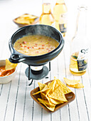 Spicy mexican cheese fondue on tortilla crisps