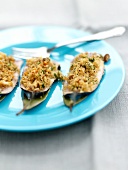 Sardines stuffed with pine nuts,bread crumbs and raisins,bay leaves and orange sauce