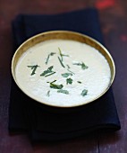 Cream of orange lentil and coconut milk soup with cilantro