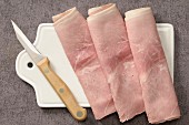 Slices of boiled ham on a chopping board