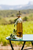 Bottle of olive oil on a table outdoors