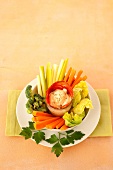 Creamy garlic and spring onion dip with raw vegetables and Chorizo