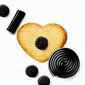 Heart-shaped biscuit with licorice candies