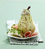 Stuffed pear with Roquefort cheese and walnuts served with raw ham