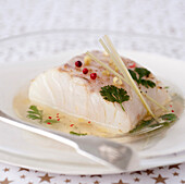 Piece of cod in a coriander and citronella-flavored broth