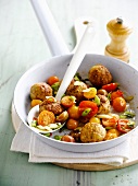 Small breaded chicken balls with cherry tomatoes