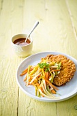 Turkey escalope breaded with cornflakes and thinly sliced vegetables
