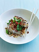 Grilled Korean dumplings with noodles and crushed peanuts