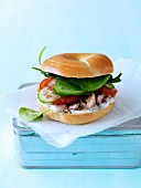 Tuna and raw vegetable bagel sandwich