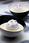 Beaten egg whites in custard with crushed sugared almonds