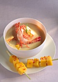 Cream of coconut soup with shrimps and mango