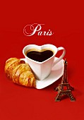 Stillleben mit Herz-Kaffeetasse, Croissant und kleinem Eiffelturm (Paris)