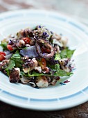 Octopus and purple potato salad with herbs