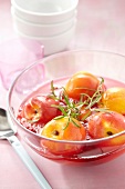 Poached peaches in syrup with rosemary