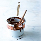 Saucepan and wooden spoon of melted chocolate
