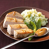 Fillet of pork with Roux sauce,mashed potatoes with herbs,sugar peas