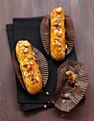 Chocolate Eclairs with caramel frosting and crushed hazelnuts