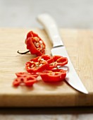 Thinly slicing a hot red pepper