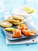Plate of smoked salmon with mini blinis