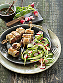 Spicy beef filo pastry brochettes,radish and cucumber salad