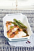 Cod with crushed tomatoes, capers, olives and green asparagus