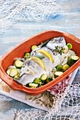 Oven-baked sea bream with onions, lemons and Brussel sprouts