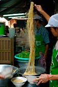 Preparing noodles in the street