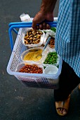 Person selling dried vegetables in the street