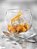 Orange fruit salad with crushed speculos ginger biscuits and whipped cream
