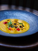 Pumpkin soup with edible flowers