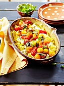 Oven-baked pasta with goat's cheese and red and yellow cherry tomatoes