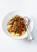 Osso-bucco-style veal stew and tagliatelles with peas