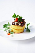 Polenta patties with stewed onions, tomatoes and gorgonzola