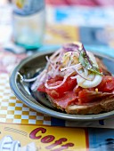 Marinated red tuna,tomato,hard-boiled egg and sliced shallots on sliced bread