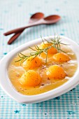 Iced apricot coulis with melon balls and rosemary