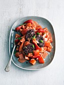 Tomato and strawberry salad with blood sausage
